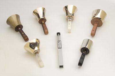 Image of seven different types of handbell type instruments.